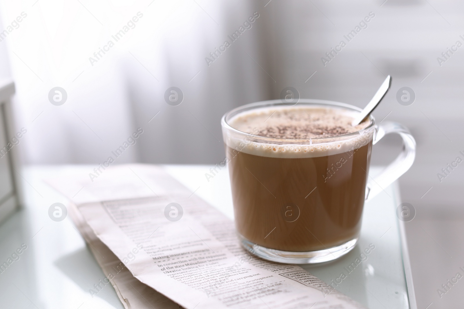 Photo of Morning coffee and newspaper on table indoors. Space for text