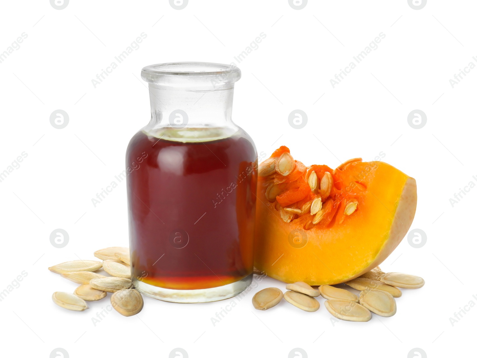 Photo of Fresh pumpkin seed oil in glass bottle isolated on white