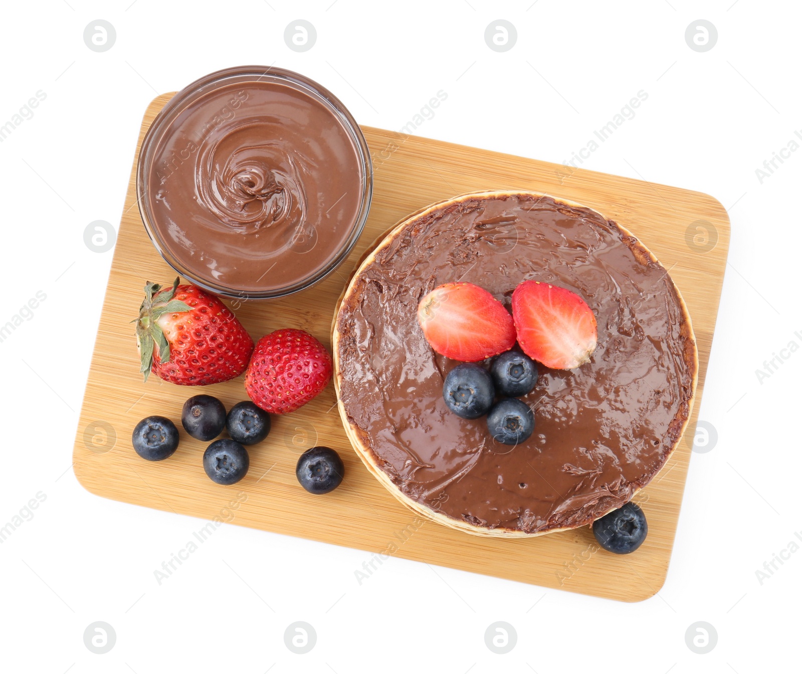 Photo of Tasty pancakes with chocolate paste and berries isolated on white, top view