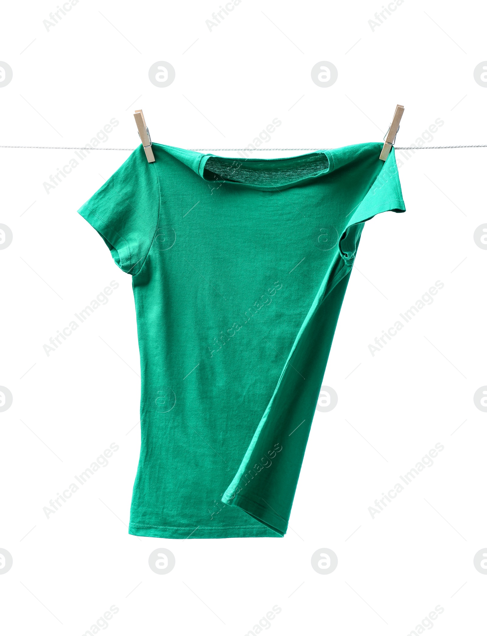 Photo of One green t-shirt drying on washing line isolated on white