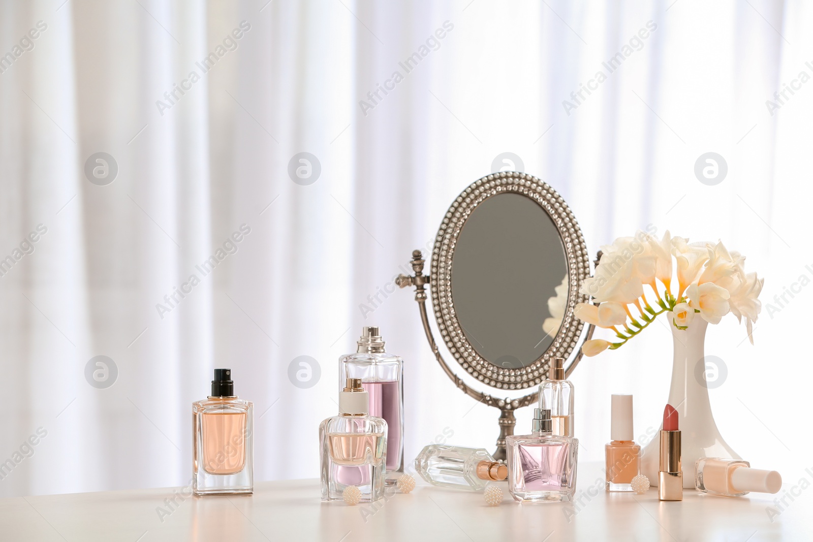 Photo of Perfume bottles on dressing table