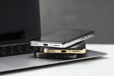 Stack of electronic devices on white table