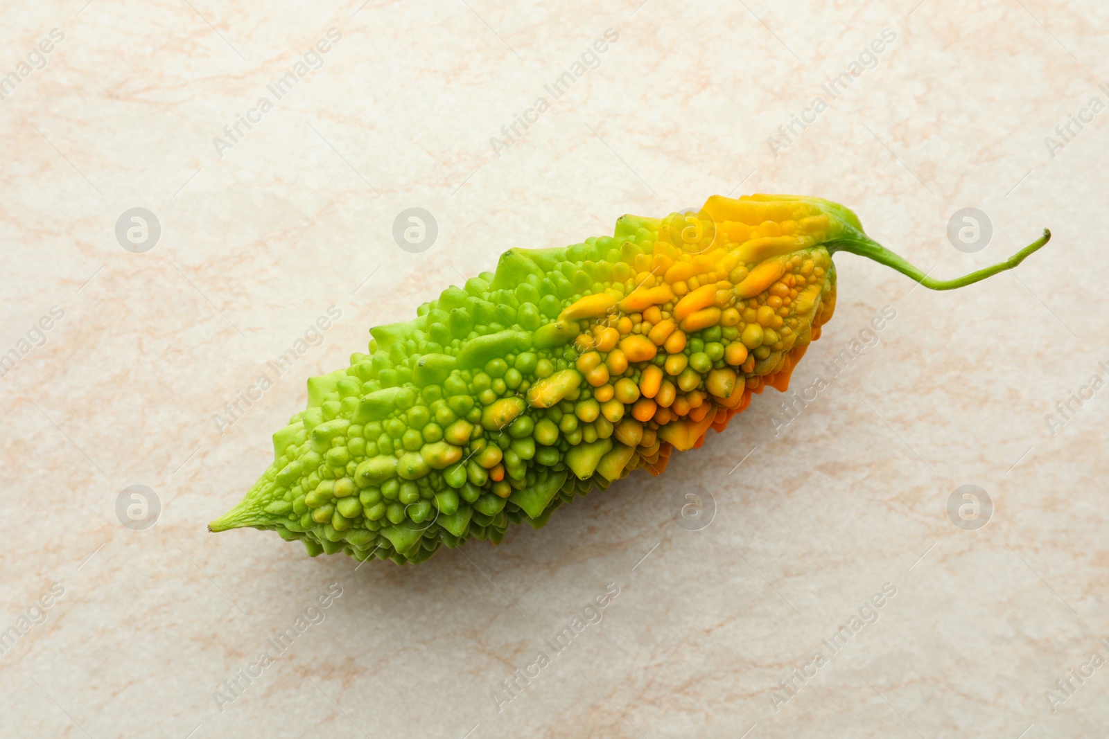 Photo of Fresh bitter melon on light table, top view