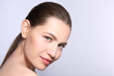 Photo of Beautiful woman with perfect eyebrows on light background