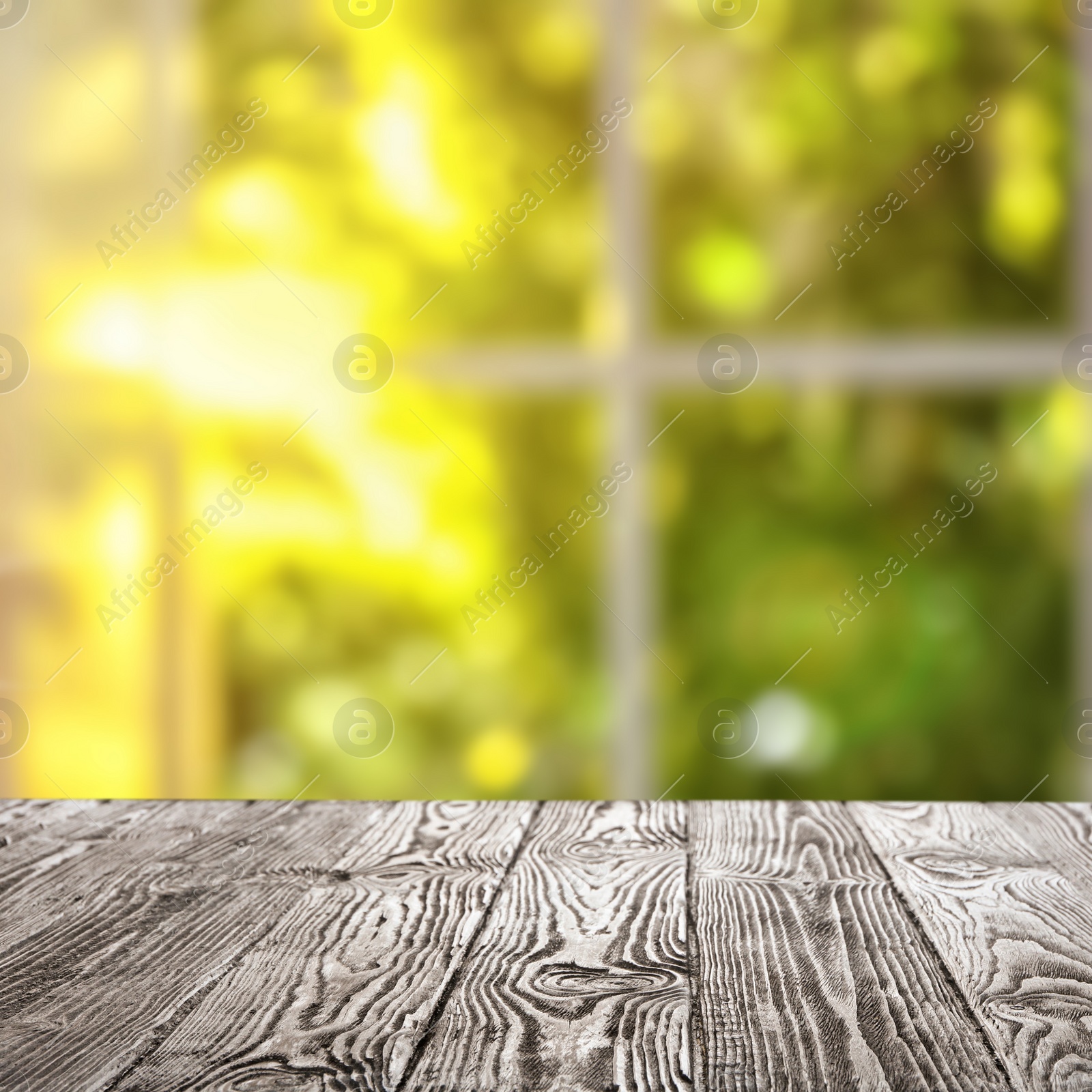 Image of Empty wooden table in front of window. Sunny morning 