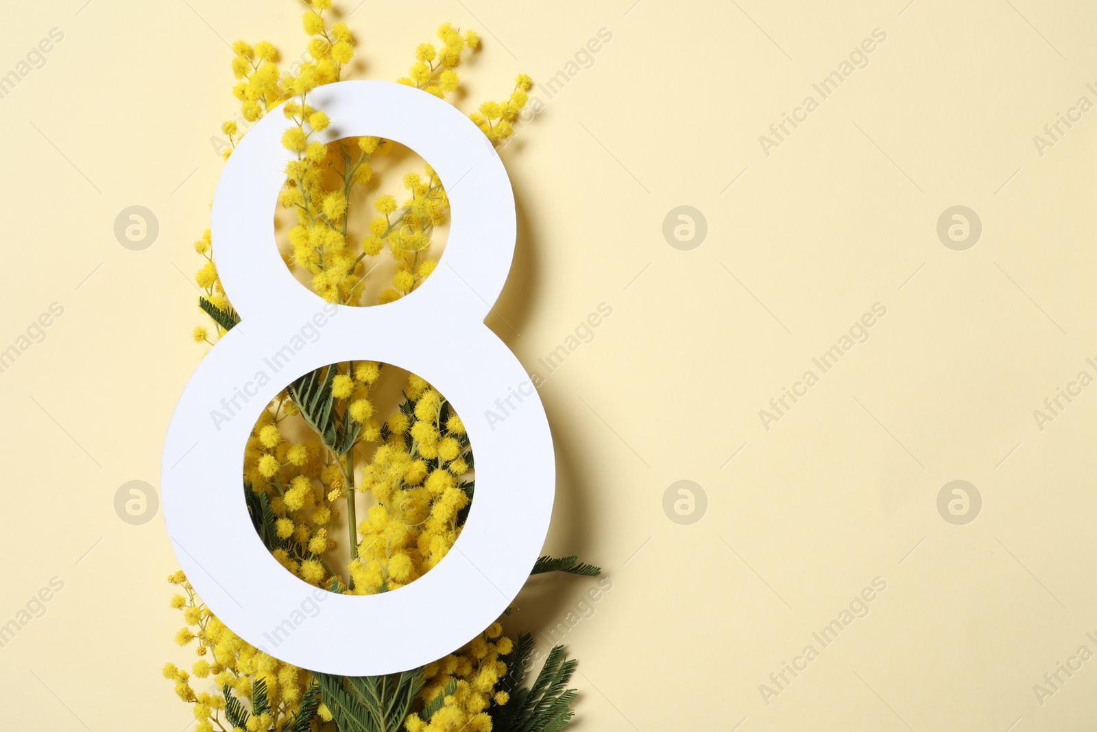 Photo of 8 March greeting card design with mimosa flowers on beige background, top view. Happy International Women's Day