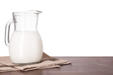 Photo of Jug of tasty milk on wooden table against white background