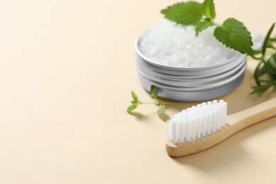 Toothbrush, salt and herbs on beige background, closeup. Space for text