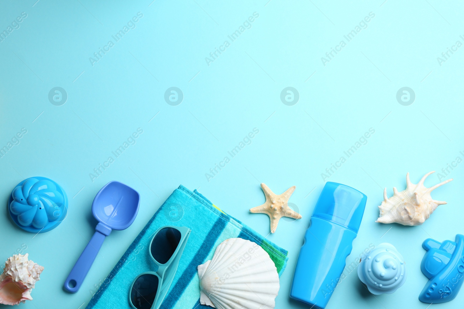 Photo of Flat lay composition with bright beach toys on color background. Space for text