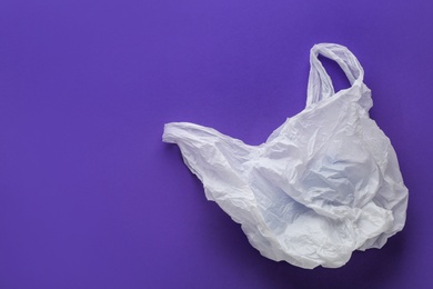 Photo of Clear disposable plastic bag on color background. Space for text