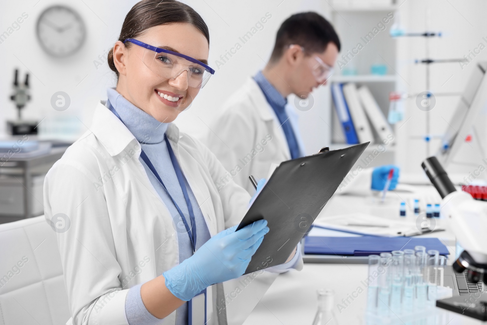 Photo of Scientists working with laboratory test form indoors. Medical research