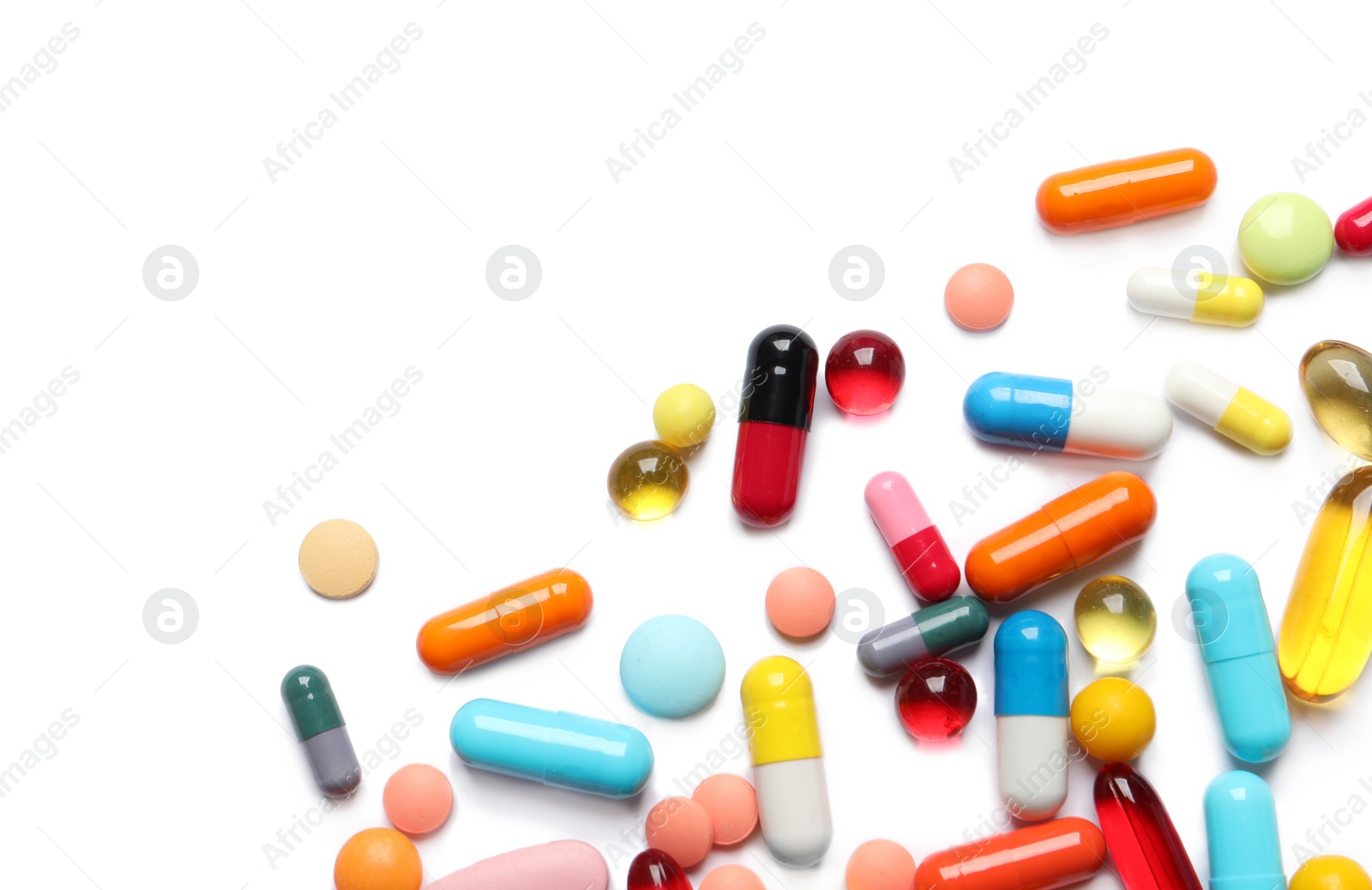 Photo of Lots of different colorful pills isolated on white, top view