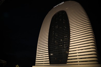BATUMI, GEORGIA - JUNE 09, 2022: Night cityscape with illuminated building of Courtyard Hotel