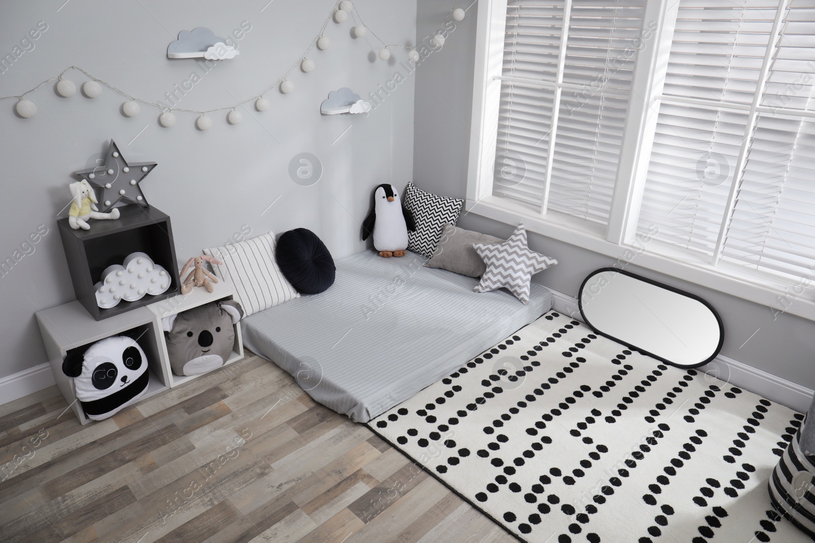 Photo of Montessori bedroom interior with floor bed and toys