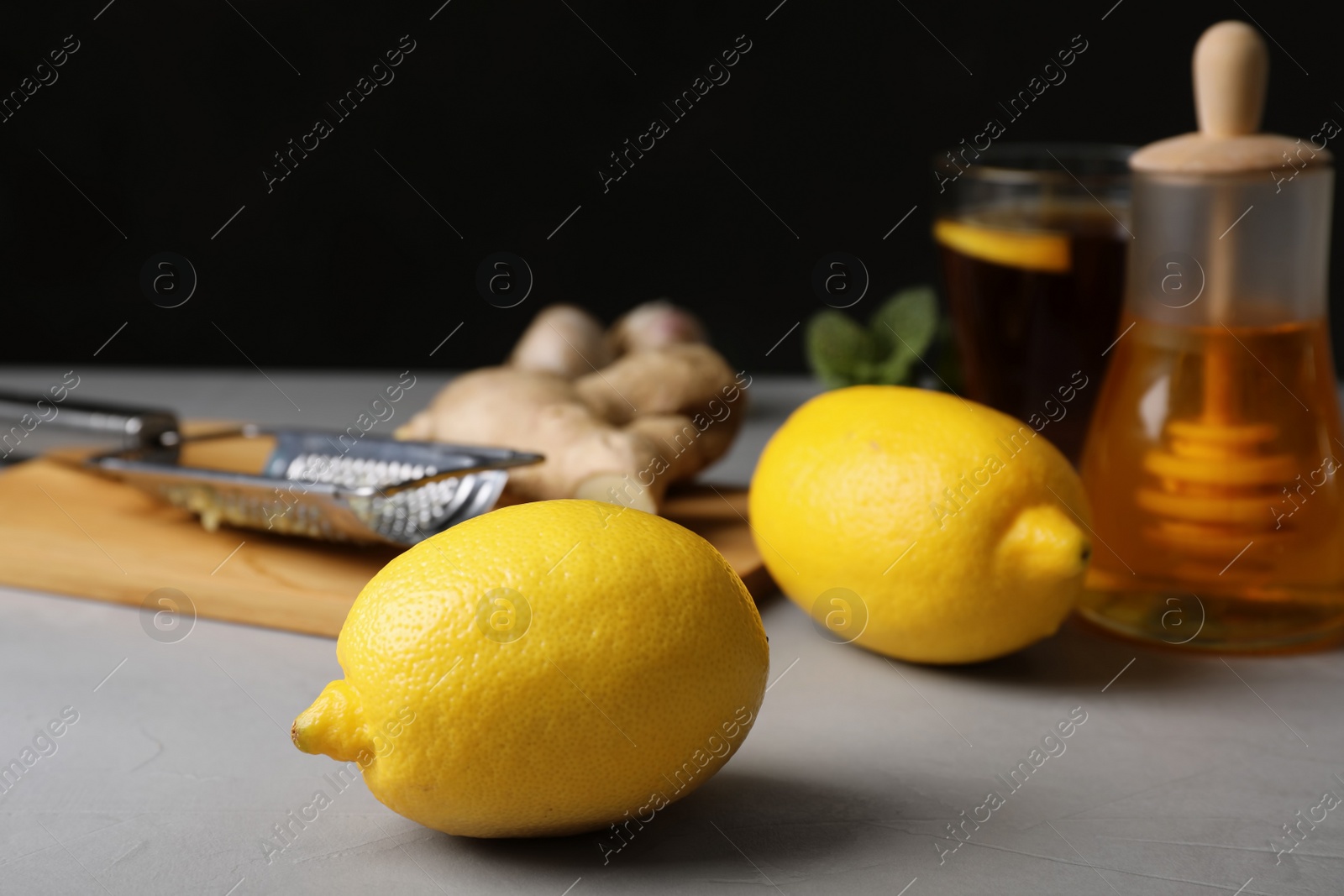 Photo of Composition with ripe lemons on kitchen table. Cough remedies