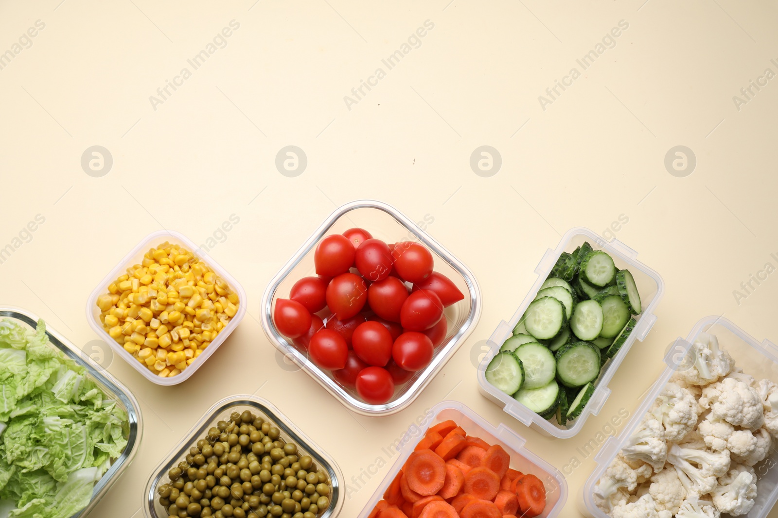 Photo of Plastic and glass containers with different fresh products on beige background, flat lay. Space for text