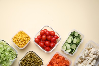 Plastic and glass containers with different fresh products on beige background, flat lay. Space for text