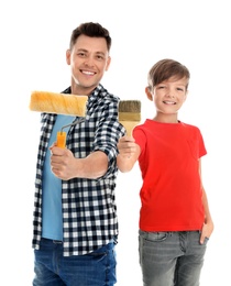 Dad and his son with painting tools on white background