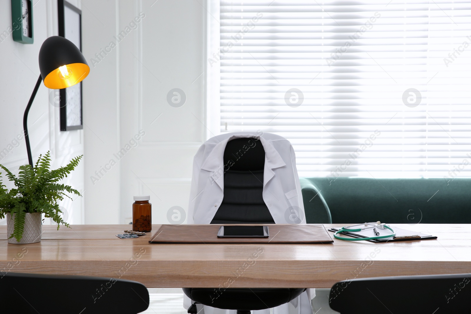 Photo of Modern doctor's workplace in stylish office. Interior design