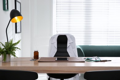 Photo of Modern doctor's workplace in stylish office. Interior design