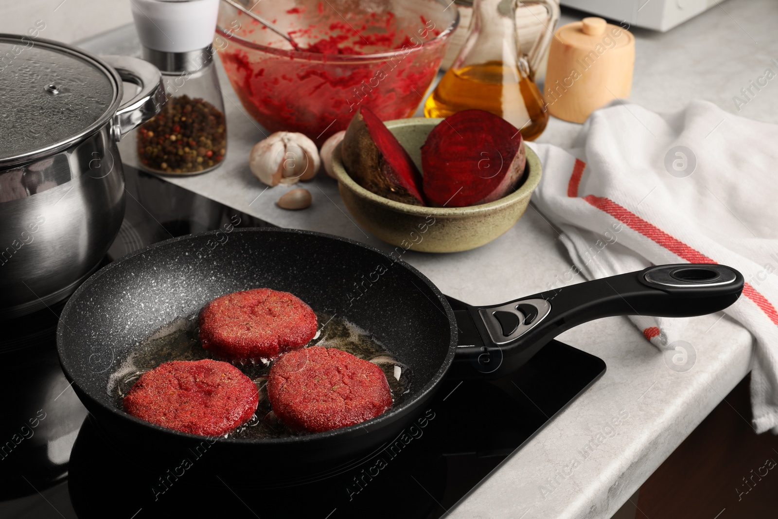 Photo of Cooking vegan cutlets in frying pan on stove