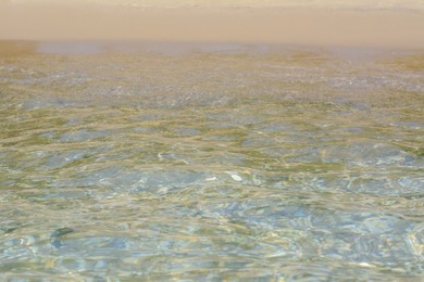 Photo of Beautiful sea water with ripples and sandy shore