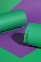 Photo of Different colorful paper sheets on green background