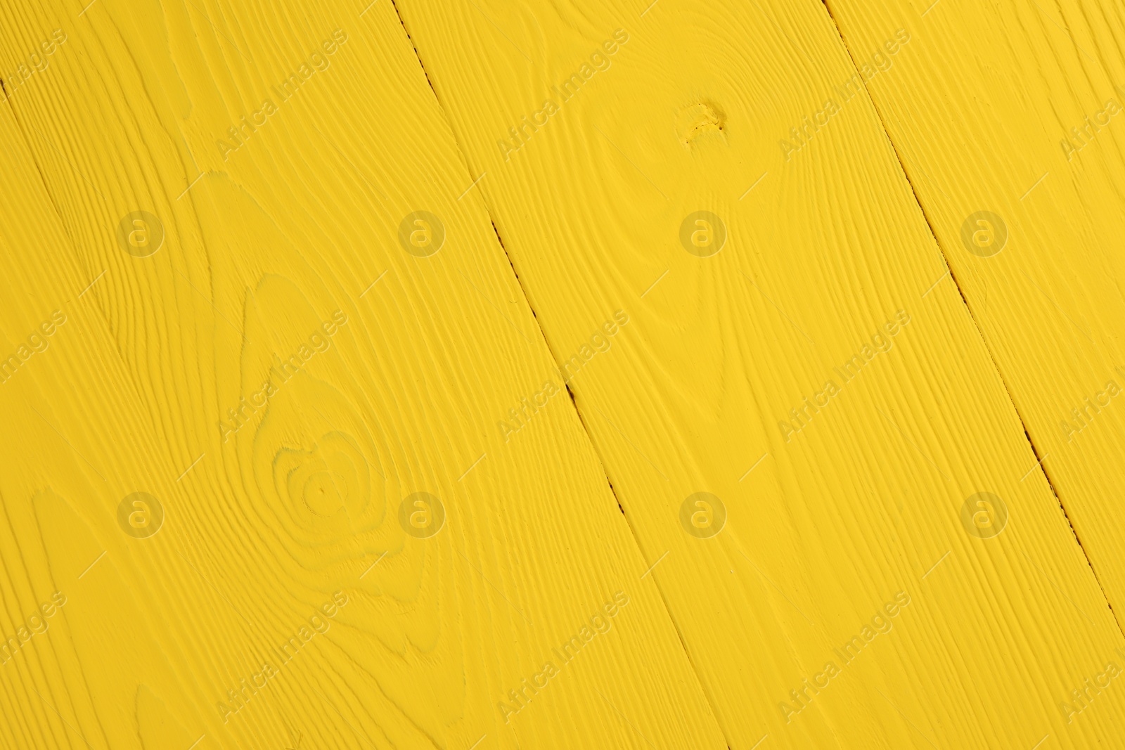 Photo of Texture of yellow wooden surface as background, closeup