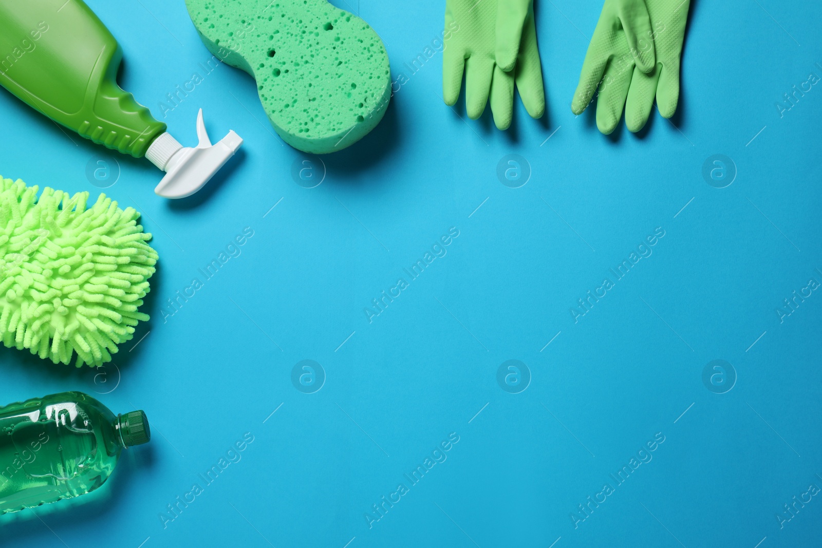 Photo of Different car wash products on light blue background, flat lay. Space for text