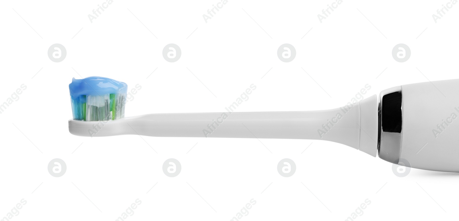 Photo of Electric toothbrush with paste on white background, closeup