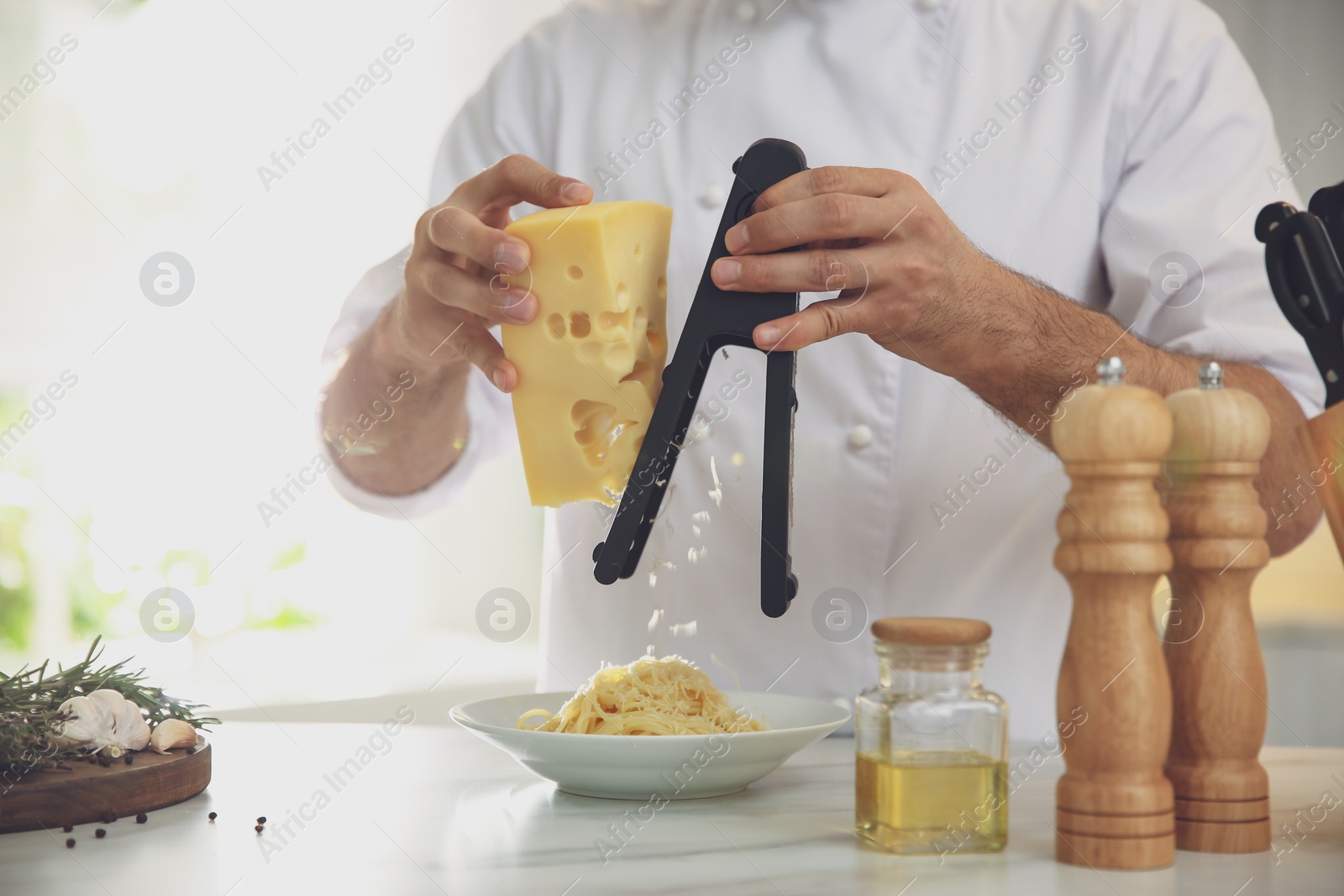 Photo of Chef cooking at table in kitchen, closeup