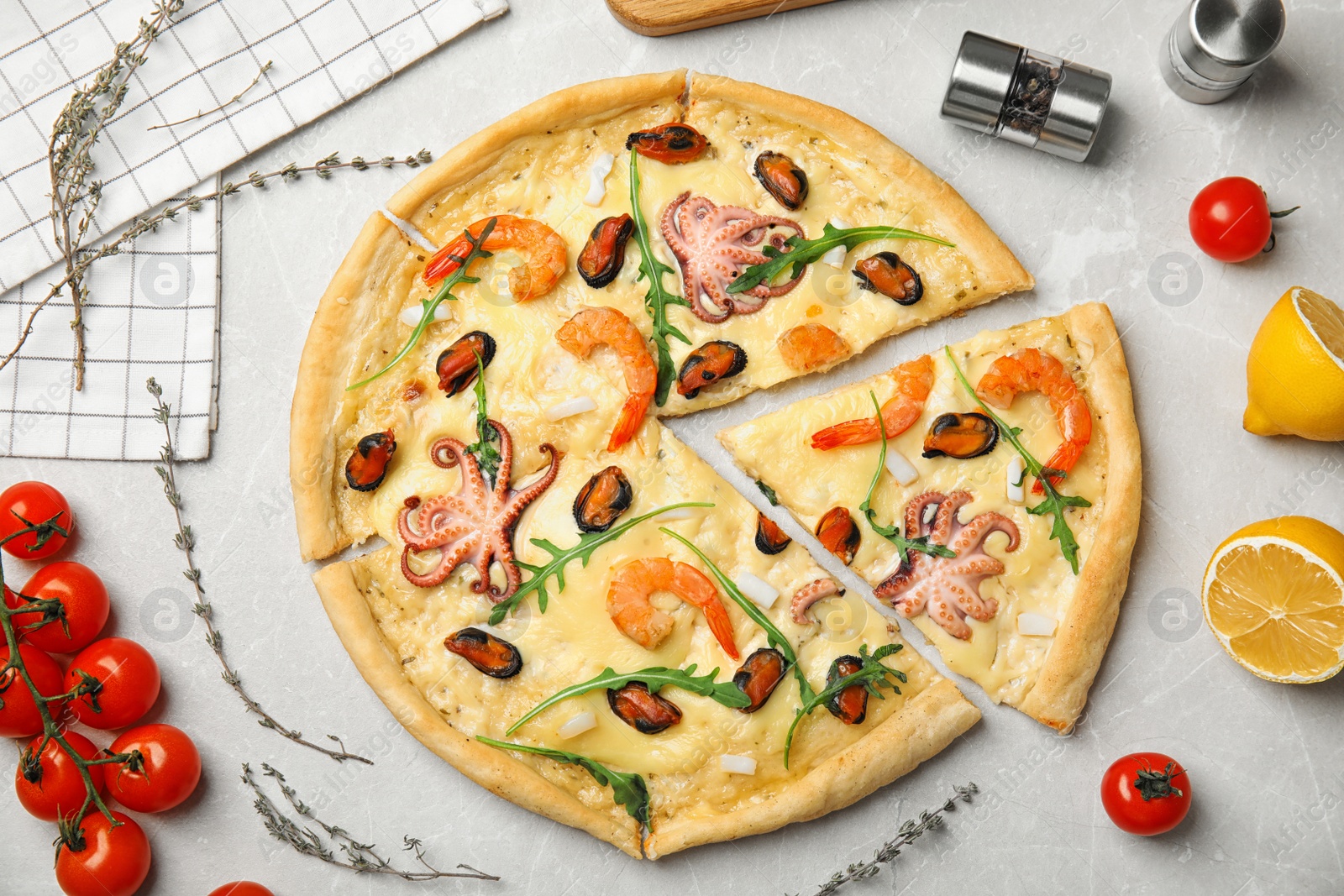 Photo of Delicious seafood pizza on grey marble table, flat lay