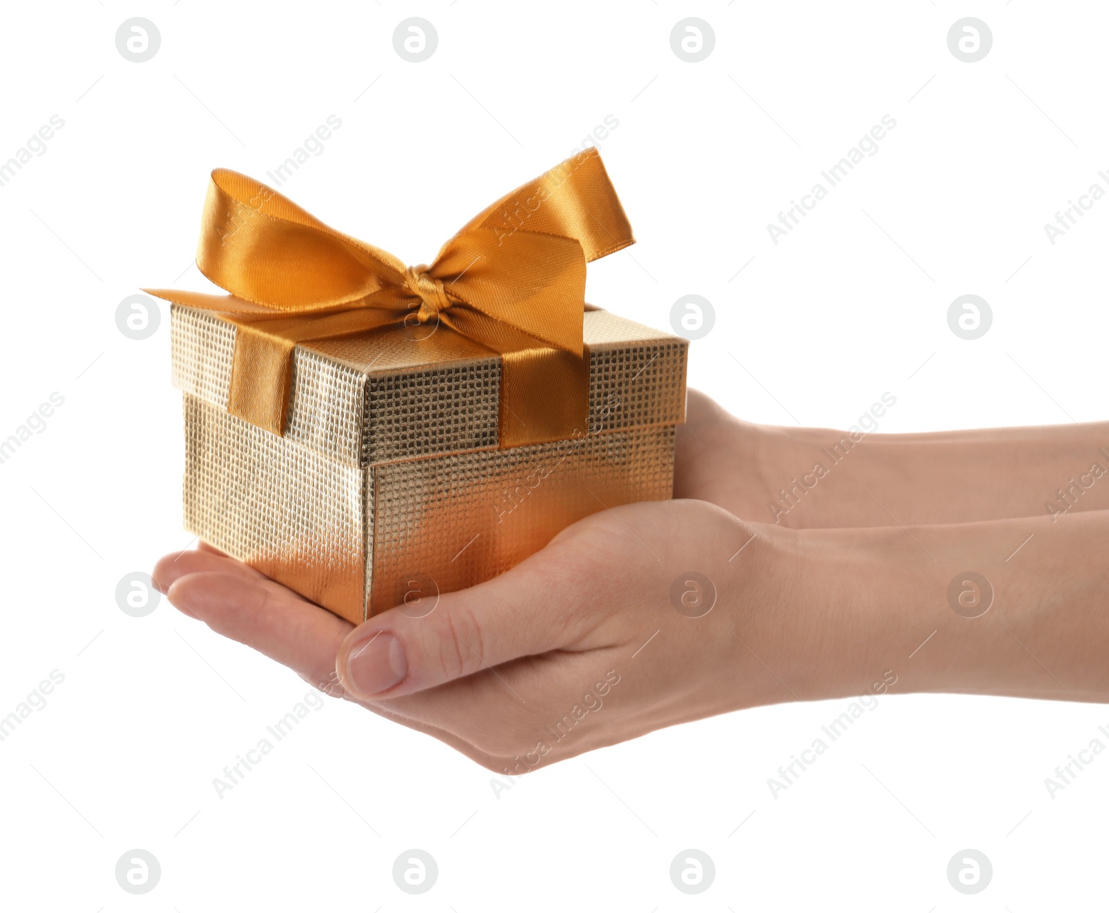 Photo of Woman holding golden gift box on white background, closeup