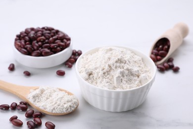Photo of Kidney bean flour and seeds on white marble table