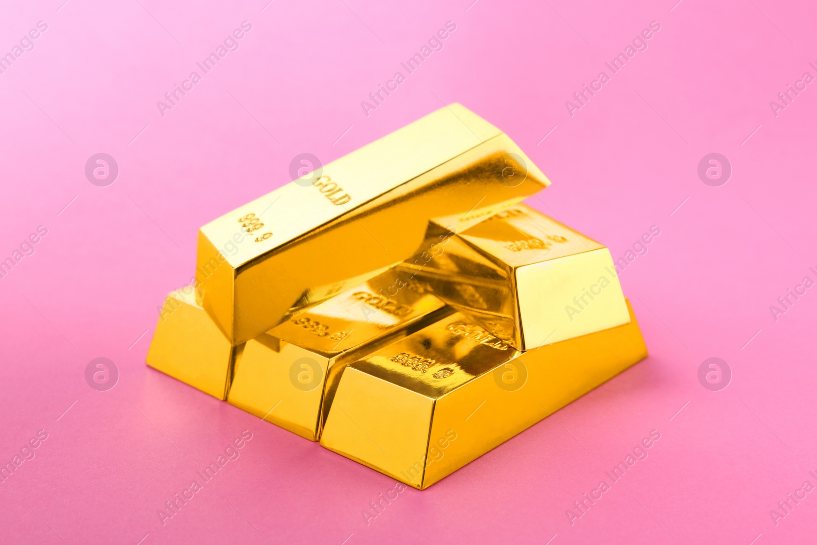 Photo of Precious shiny gold bars on color background