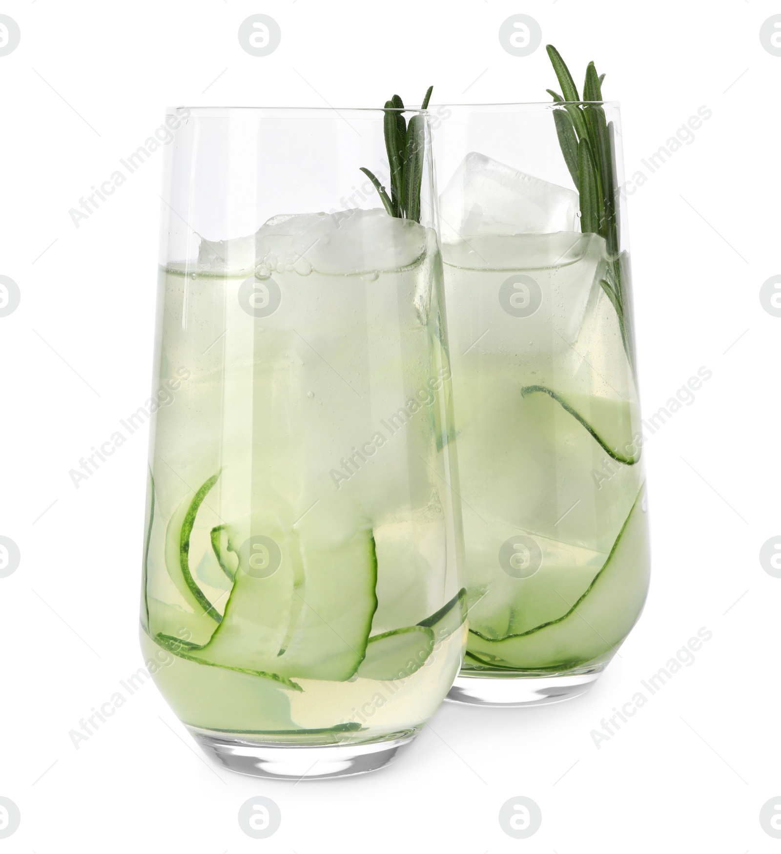 Photo of Glasses of refreshing cucumber lemonade and rosemary on white background. Summer drink