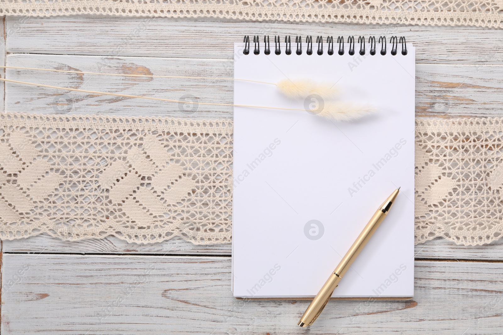 Photo of Guest list. Notebook, pen, spikelets and lace ribbon on wooden background, flat lay. Space for text