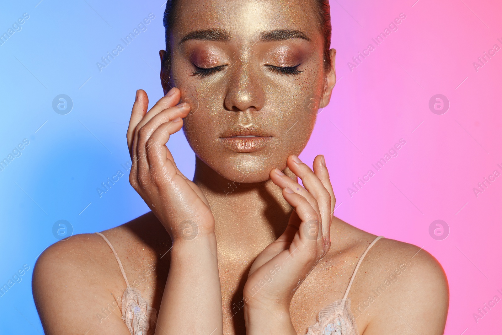 Photo of Beautiful young woman with glitter makeup on colorful background