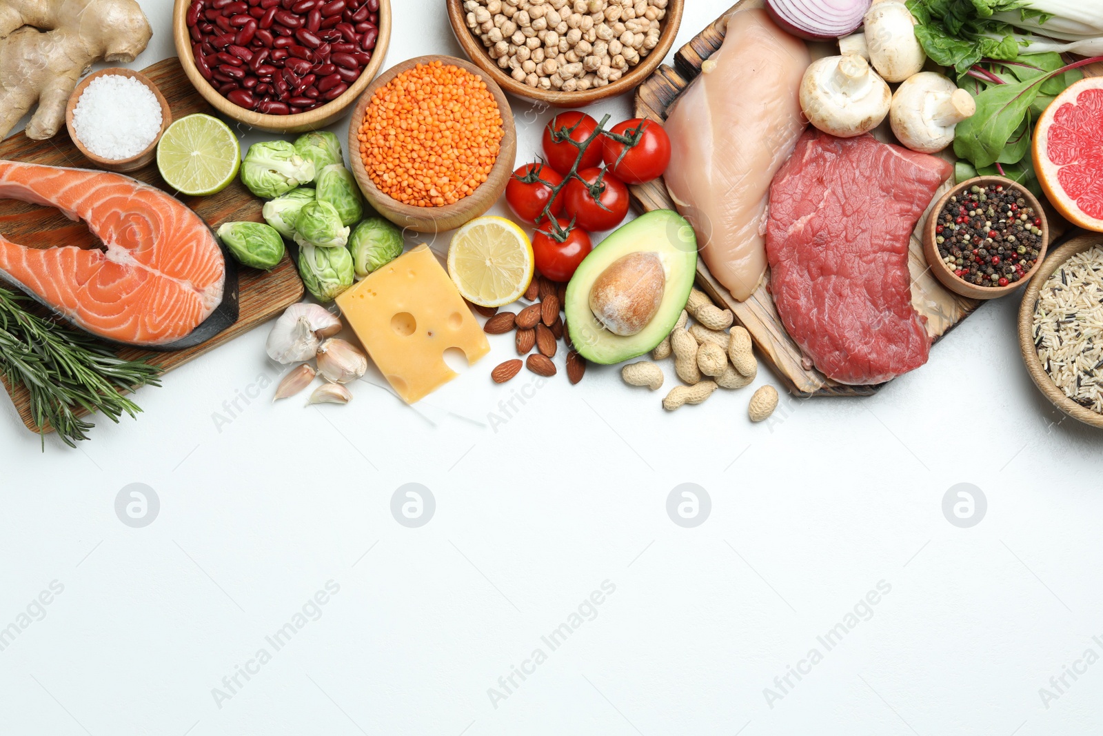 Photo of Flat lay composition with fresh meat and other products on white background, space for text. Balanced diet