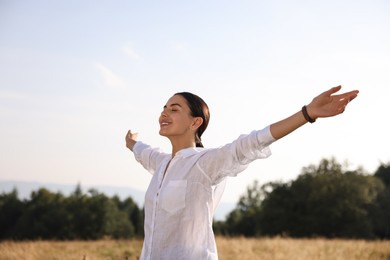 Photo of Feeling freedom. Happy woman with wide open arms outdoors