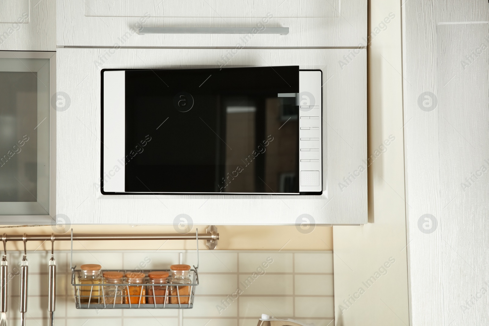 Photo of Open modern microwave oven built in kitchen furniture