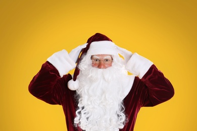 Portrait of emotional Santa Claus on yellow background