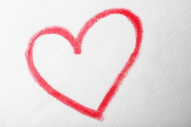 Heart drawn with lipstick on paper napkin, top view