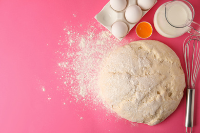 Photo of Flat lay composition with dough for pastries on pink background. Space for text