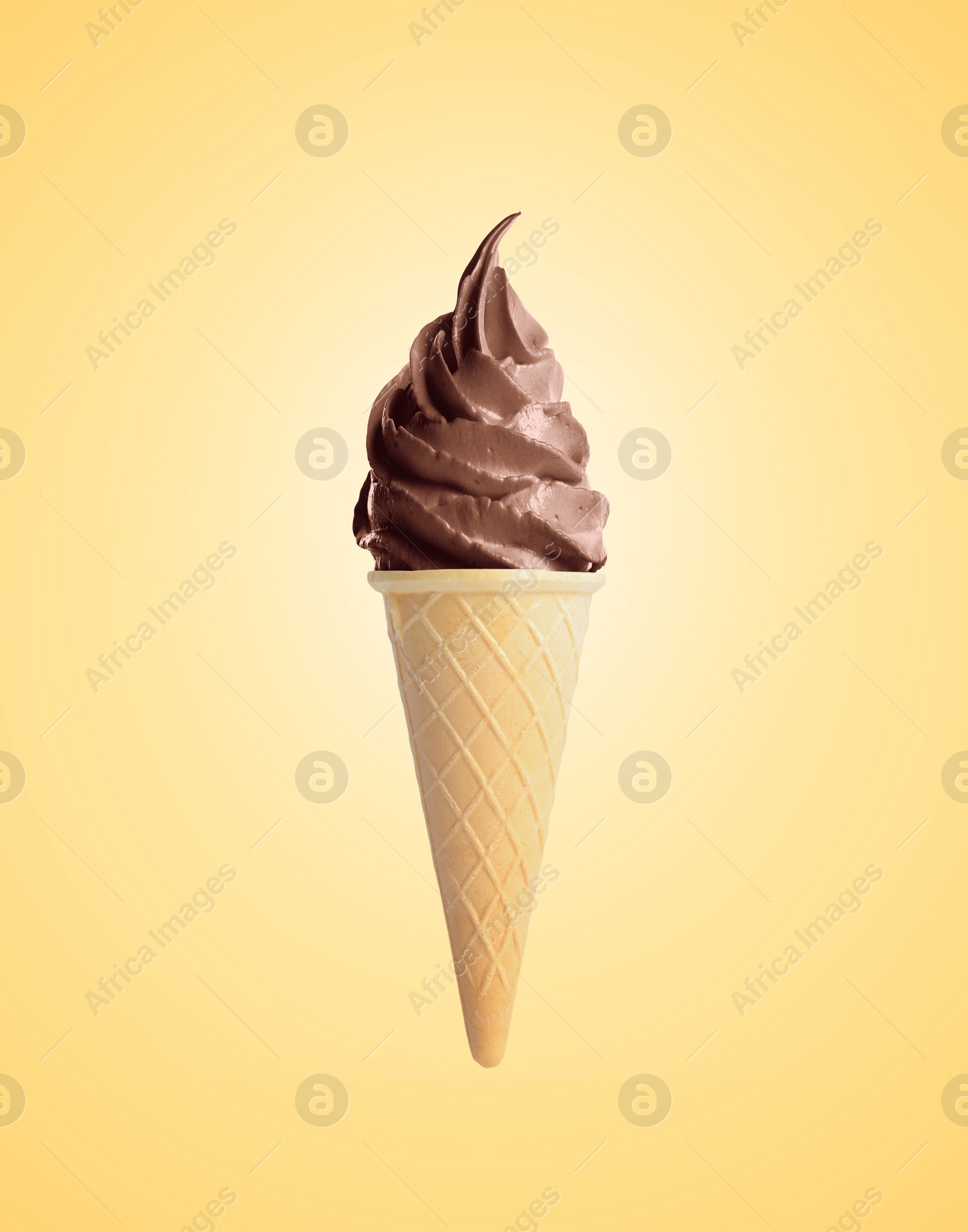 Image of Delicious soft serve chocolate ice cream in crispy cone on pastel golden background