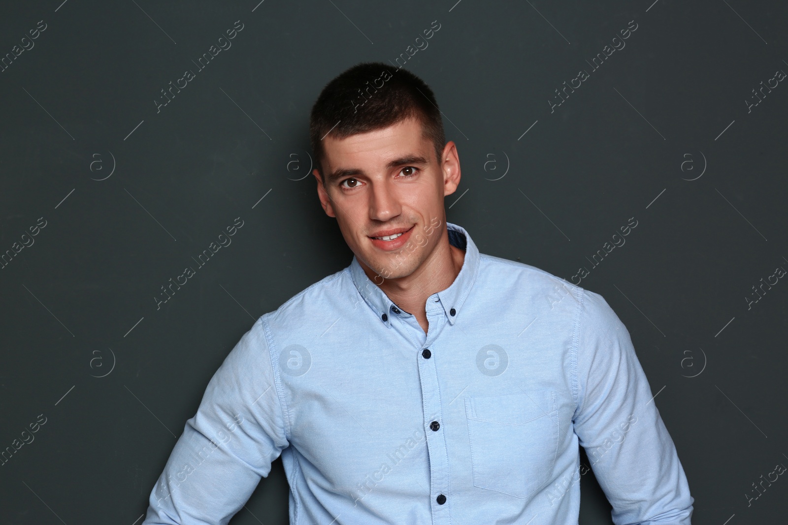 Photo of Portrait of handsome young man on dark background