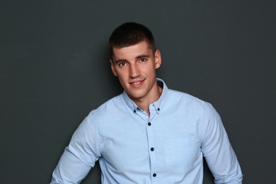 Portrait of handsome young man on dark background