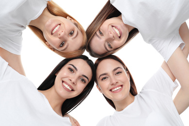 Photo of Beautiful young ladies hugging on white background, bottom view. Women's Day