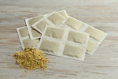 Mustard powder and plasters on wooden table