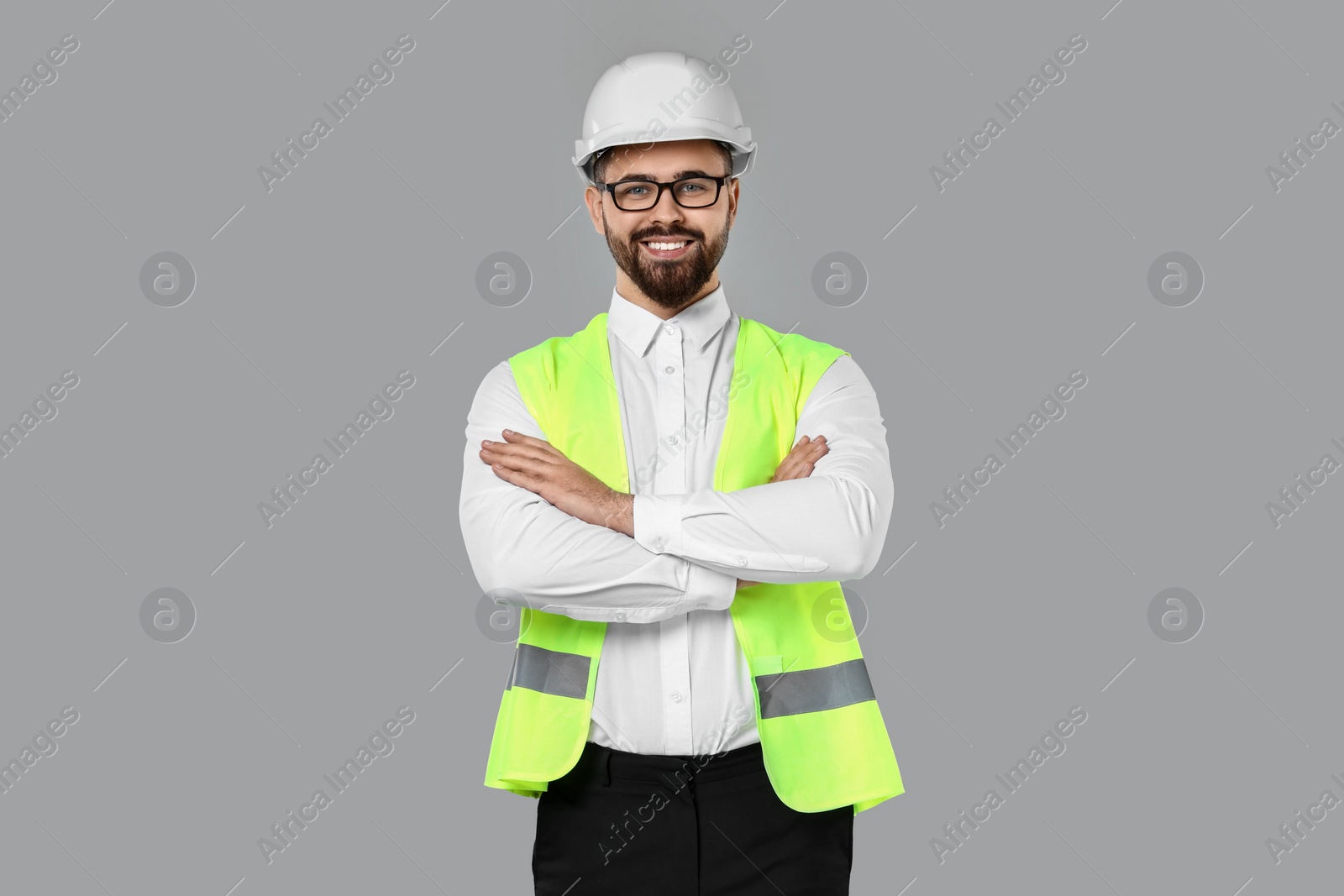 Photo of Engineer in hard hat on grey background